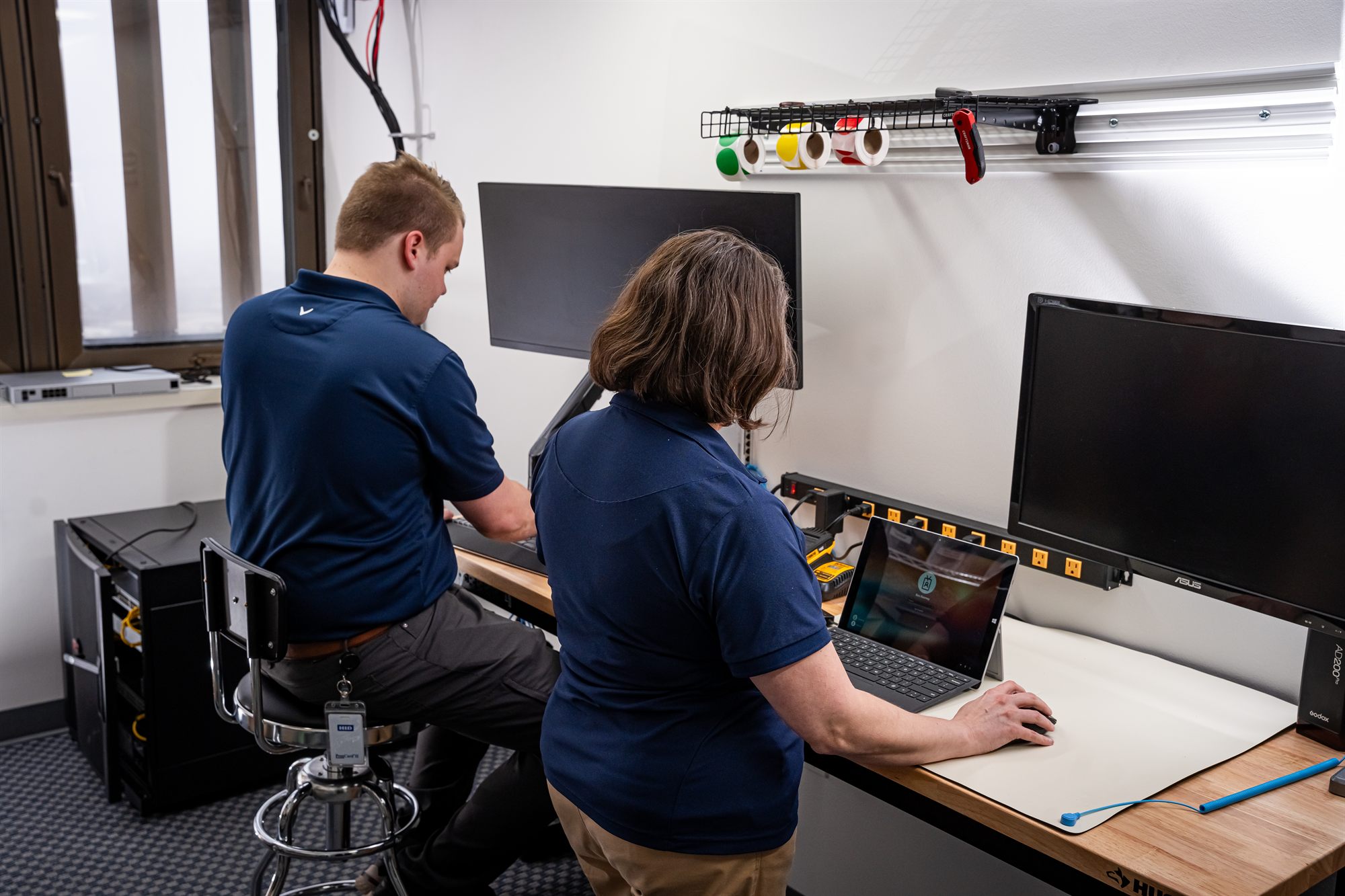 Two NSN Management technicians working through an issue together at the Tulsa office