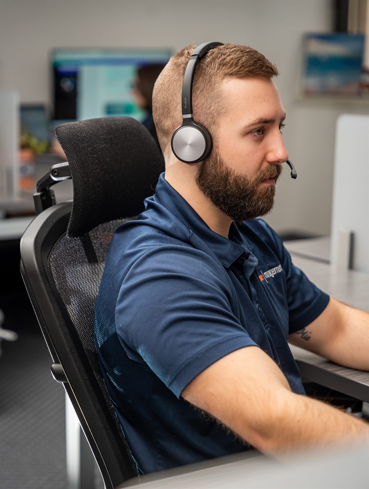 An NSN Management help desk technician on a call at the Tulsa office